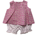 Baby outfit with pink floral top and white bloomers on a white background