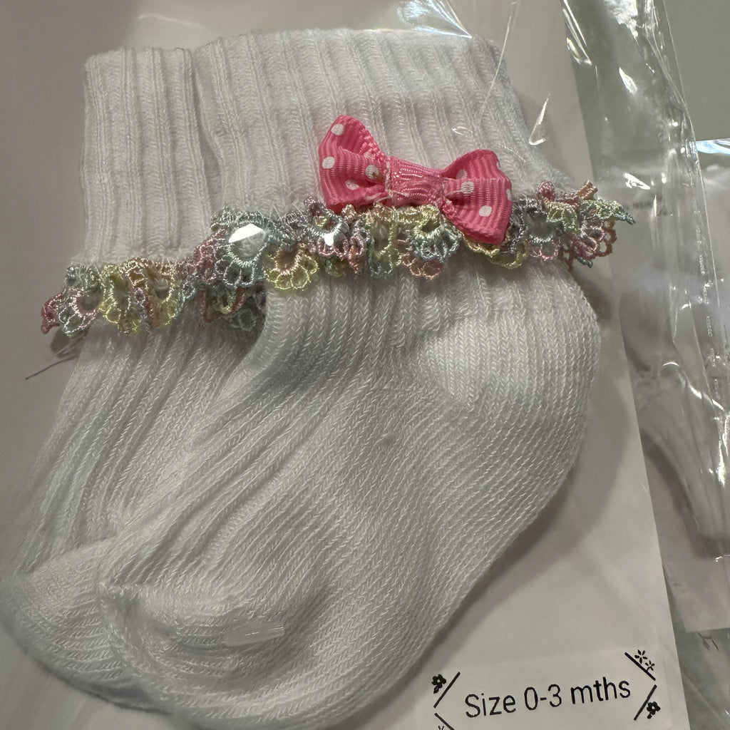 White baby cotton socks with pale rainbow lace trim and bow.