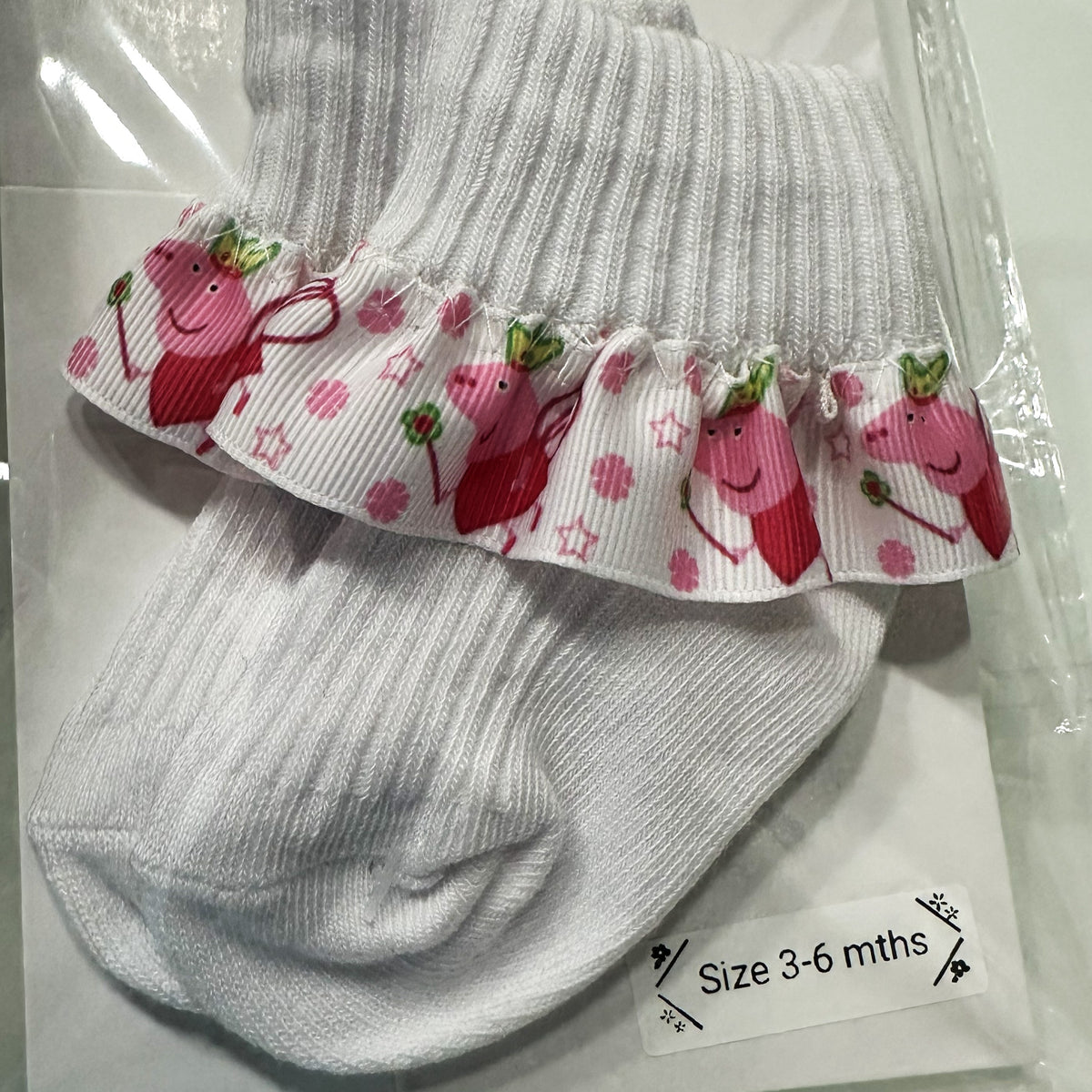 White baby cotton socks with pepper pig ribbon trim.
