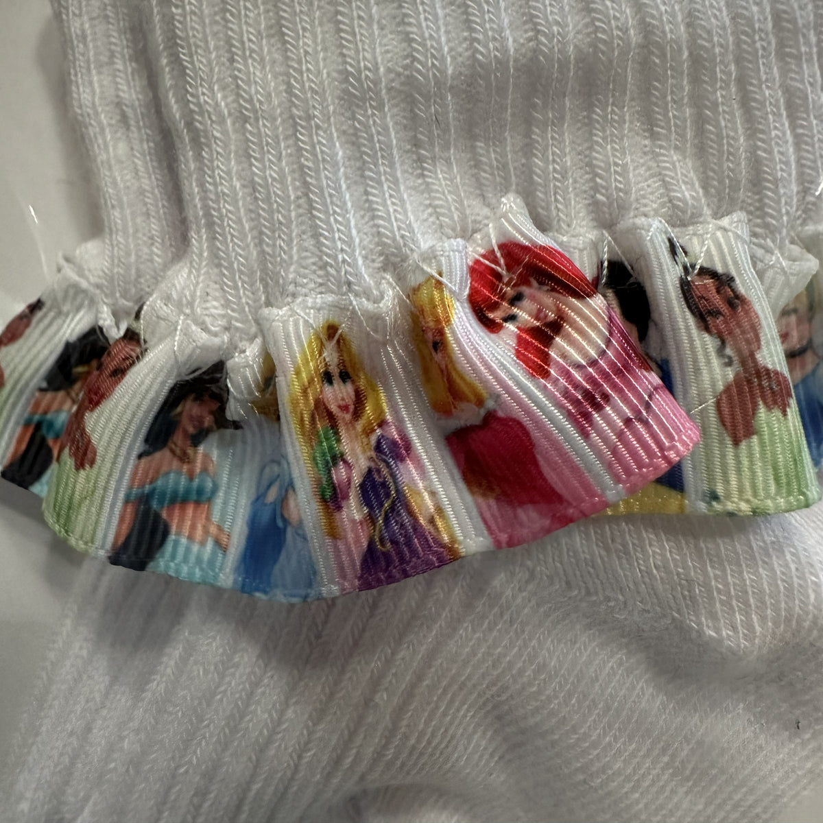 White baby cotton socks with Disney princess ribbon trim.